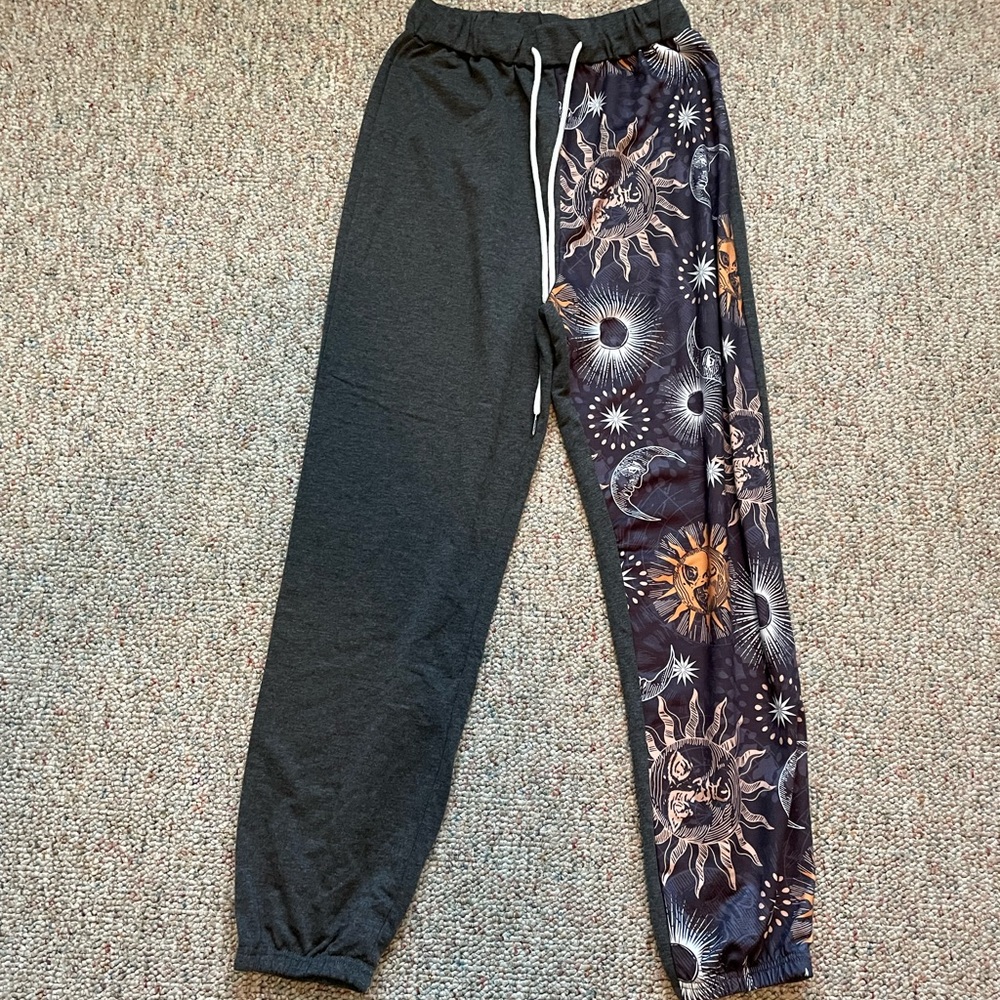 SHEIN size small asymmetrical sweat pants with suns and moons on leg